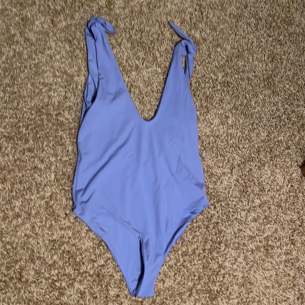 One piece, purple swimsuit with a low back. BRAND NEW.